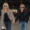 Rod Stewart et sa femme Penny Lancaster arrivent à l'aéroport Heathrow de Londres le 11 septembre 2014