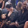 Kim Kardashian, North et Kanye West assistent au défile Givenchy printemps-été 2015 au lycée Carnot. Paris, le 28 septembre 2014.