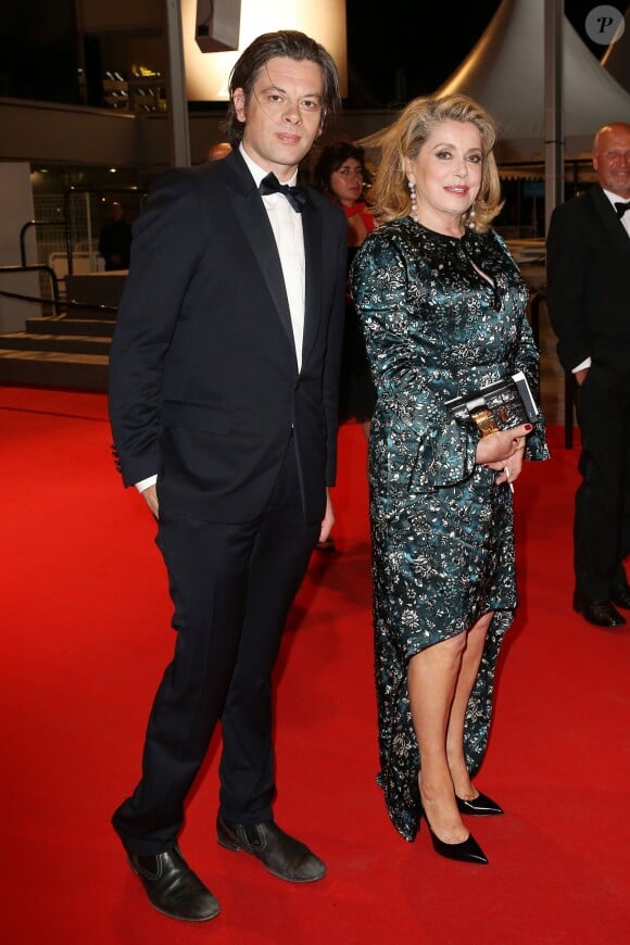 Benjamin Biolay et Catherine Deneuve - Descente des marches du film "L'homme qu'on aimait trop" lors du 67e Festival du film de Cannes le 21 mai 2014.