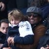 Yannick Noah et son fils Joalukas lors de la victoire du PSG face à Evian Thonon Gaillard au Parc des Princes à Paris le 18 janvier 2015