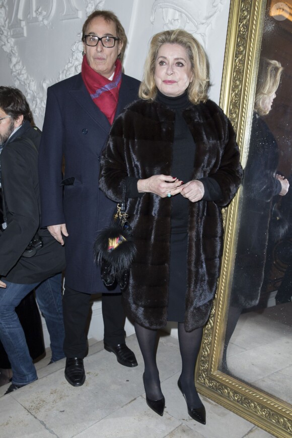 Gilles Dufour et Catherine Deneuve - Personnalités au défilé de mode Jean Paul Gaultier, collection Haute Couture printemps-été 2015 à Paris le 28 janvier 2015.