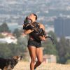 Montana Fishburne, la fille de Laurence Fishburne, joue avec ses chiens a Hollywood Hills, le 29 juillet 2013. 