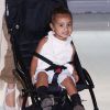 North West, confortablement assise dans sa poussette, arrive à l'aéroport de Roissy-Charles-de-Gaulle avec ses parents Kim Kardashian et Kanye West. Roissy, le 14 avril 2015.