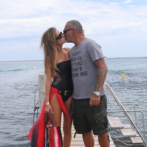 Christian Audigier et sa fiancee Nathalie Sorensen arrivent au club 55 a Saint Tropez le 8 aout 2013.