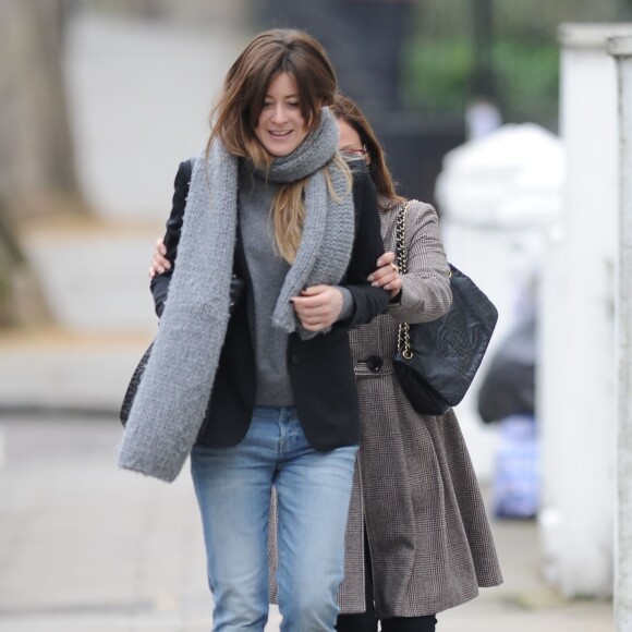 Natalie Imbruglia s'amuse à se cacher derrière une amie dans la rue dans le quartier de Notting Hill à Londres, le 16 mars 2015.  