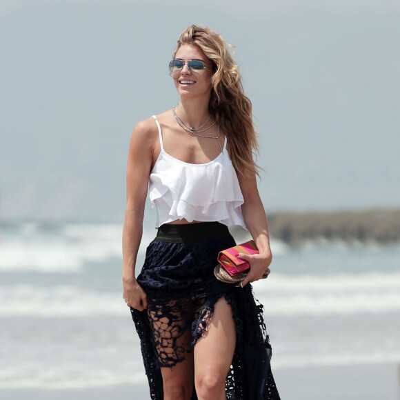 Exclusif - AnnaLynne McCord, craquante en top blanc et jupe en crochet, se promène sur une plage à Los Angeles, le 26 août 2015.