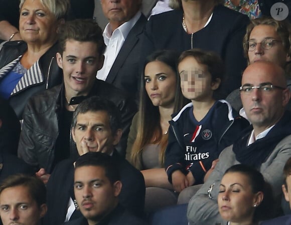 Louis Sarkozy et Capucine Anav avec le jeune Solal Sarkozy, fils de Jean, le 16 août 2015 au Parc des Princes lors de la victoire du PSG contre le GFC Ajaccio.