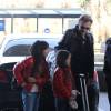 Exclusif - Johnny Hallyday et ses filles Jade et Joy - La famille Hallyday arrive à l'aéroport de Roissy pour prendre un vol pour aller passer leurs vacances en Thaïlande avec des amis le 19 décembre 2015