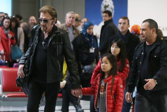 Exclusif - Johnny Hallyday et ses filles Jade et Joy - La famille Hallyday arrive à l'aéroport de Roissy pour prendre un vol pour aller passer leurs vacances en Thaïlande avec des amis le 19 décembre 2015.