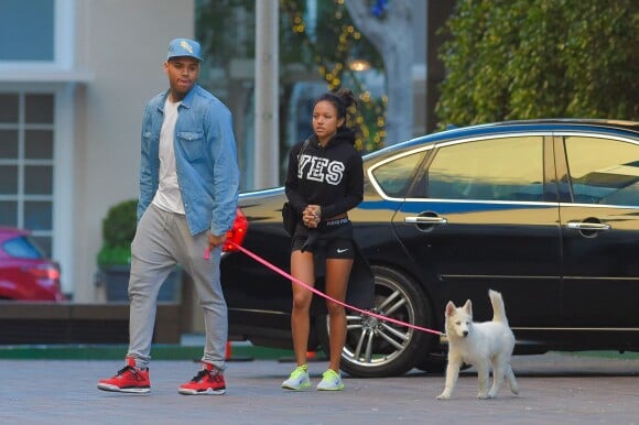 Possibly engaged couple Chris Brown and Karrueche Tran head indoors out of the cold for some shopping together at Nike Town in Beverly Hills, Los Angeles, CA, USA on December 26, 2014. Chris may be finally settling down and committing after his on-again, off-again girlfriend Karrueche Tran sparked engagement rumors on Christmas. The model got fans talking on Christmas Day when she shared a photo via Instagram. Captioned with a heart, the shot shows Tran's hand, adorned with two massive rings. Though they are on her right hand, the impressive pieces of jewelry both look like engagement rings. On her ring finger, Tran sports a smaller, though still eye-catching, cushion-cut diamond. On her well-manicured pointer finger rests a huge oval-cut diamond with yellow tones. Soon after Tran posted the photo, rumor spread that the rings were from Brown, and many speculated that they were engagement rings. Photo by GSI/ABACAPRESS.COM27/12/2014 - Los Angeles