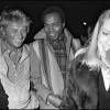 Johnny Hallyday, Alan Coriolan et Catherine Deneuve en 1980 lors d'une soirée au 78 à Paris.