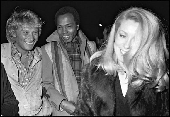 Johnny Hallyday, Alan Coriolan et Catherine Deneuve en 1980 lors d'une soirée au 78 à Paris.