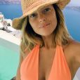 Caroline Receveur et son chéri Valentin profitent de vacances ensoleillées sur l'île de Santorin en Grèce. La jolie blonde pose dans un sexy maillot de bain orange. Mai 2015.