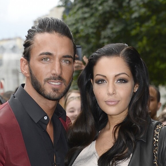 Nabilla Benattia embrasse son compagnon Thomas, lorsqu'elle arrive au defile de mode Jean-Paul Gaultier a Paris. Le 3 juillet 2013