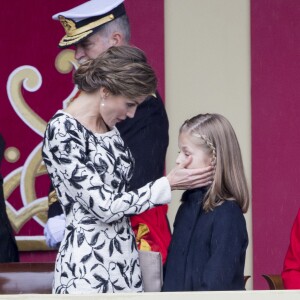 Un joli geste tendre de Letizia avec Leonor... Le roi Felipe VI et la reine Letizia d'Espagne étaient accompagnés par leurs filles la princesse Leonor des Asturies (manteau bleu) et l'infante Sofia d'Espagne (manteau rouge) le 12 octobre 2016 à Madrid pour le défilé militaire de la Fête nationale espagnole.