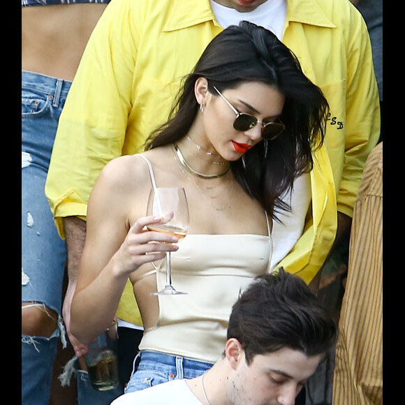 Kendall Jenner se balade, s'amuse, discute et boit un verre avec des amis sur une plage à Miami, le 4 décembre 2016