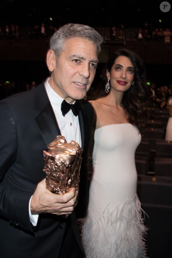 George Clooney (César d'honneur - Montre Omega) et sa femme Amal Clooney (enceinte) - 42ème cérémonie des César à la salle Pleyel à Paris le 24 février 2017. © Olivier Borde / Dominique Jacovides / Bestimage