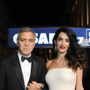 Exclusif - George Clooney (montre Omega) et sa femme Amal Clooney (enceinte) - Arrivées à la 42ème cérémonie des Cesar à la salle Pleyel à Paris, le 24 février 2017.