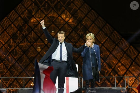 Emmanuel Macron, élu président de la république, et sa femme Brigitte Macron (Trogneux), saluent les militants devant la pyramide au musée du Louvre à Paris, après sa victoire lors du deuxième tour de l'élection présidentielle. Le 7 mai 2017. F