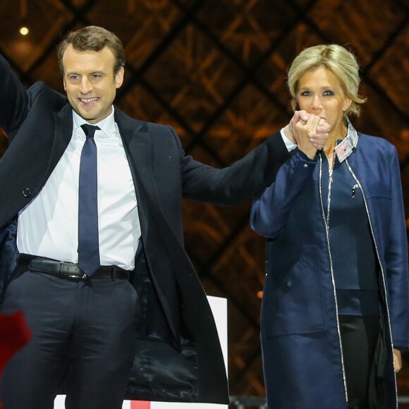 Emmanuel Macron, élu président de la république, et sa femme Brigitte Macron (Trogneux), saluent les militants devant la pyramide au musée du Louvre à Paris, après sa victoire lors du deuxième tour de l'élection présidentielle. Le 7 mai 2017.