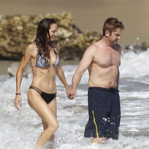 Gerard Butler et sa compagne Morgan Brown s'embrassent sur la plage de Malibu le 12 octobre 2015.