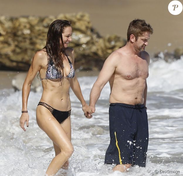 Gerard Butler et sa compagne Morgan Brown s'embrassent sur la plage de Malibu le 12 octobre 2015.
