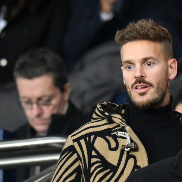 Matt Pokora (M. Pokora) dans les tribunes du parc des Princes lors du match de football de ligue 1, opposant le Paris Saint-Germain (PSG) contre l'Olympique de Marseille (OM) à Paris, France, le 17 mars 2019.