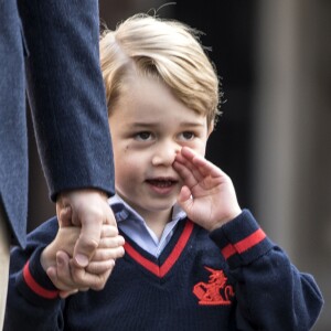 Le prince George de Cambridge, ici accueilli par la directrice Helen Haslem, a fait sa première rentrée des classes à l'école Thomas's Battersea le 7 septembre 2017 à Londres, escorté par son père le prince William. Sa mère Kate Middleton n'était pas en état de l'accompagner, souffrant des symptômes du début de sa troisième grossesse révélée quelques jours plus tôt.