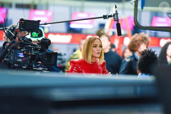 Jennifer Lopez dans une robe rouge à paillettes lors du tournage de "Marry Me" à l'aéroport JFK à New York le 9 novembre 2019.