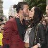Nabilla Benattia embrasse son compagnon Thomas, lorsqu'elle arrive au defile de mode Jean-Paul Gaultier a Paris. Le 3 juillet 2013