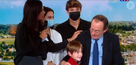 Jean-Pierre Pernau ému, sa femme Nathalie Marquay, ses enfants Tom et Lou et son petit-fils Léo sur le plateau du JT de 13h de TF1, le 18 décembre 2020