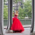 Gaëlle Petit (émission "Les Ch'tis" sur W9) pose dans une robe rouge lors d'un shooting photo sur le pont de Bir-Hakeim à Paris, le 26 mai 2016.