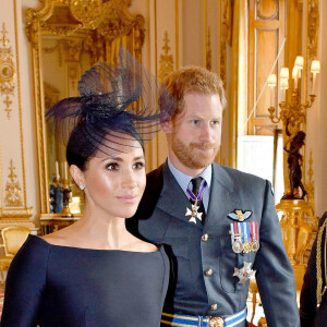 Le prince Harry, duc de Sussex et Meghan Markle, duchesse de Sussex (habillée en Dior Haute Couture par Maria Grazia Chiuri) - La famille royale d'Angleterre à la réception du 100ème anniversaire de la RAF au palais de Buckingham à Londres. Le 10 juillet 2018 