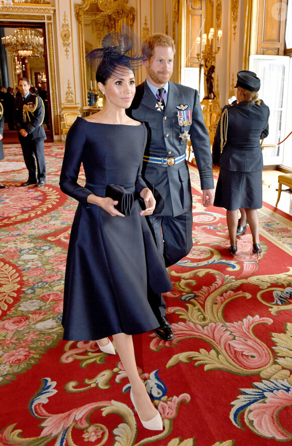 Le prince Harry, duc de Sussex et Meghan Markle, duchesse de Sussex (habillée en Dior Haute Couture par Maria Grazia Chiuri) - La famille royale d'Angleterre à la réception du 100ème anniversaire de la RAF au palais de Buckingham à Londres. Le 10 juillet 2018 