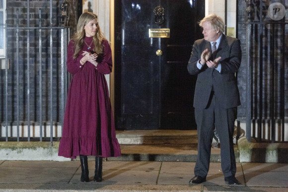 Le premier ministre Boris Johnson et sa compagne Carrie Symonds applaudissent devant le 10 Downing Street pour rendre hommage au capitaine Tom Moore, vétéran et héros du confinement décédé à l'âge de 100 ans. Londres, le 3 février 2021 © Ray Tang / Zuma Press / Bestimage