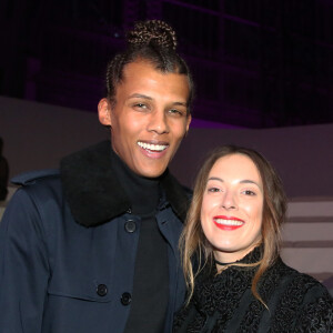 Stromae (nouvelle coupe de cheveux) et sa femme Coralie Barbier au défilé "Victoria's Secret Paris 2016" au Grand Palais à Paris, le 30 novembre 2016. © Denis Guignebourg/Bestimage