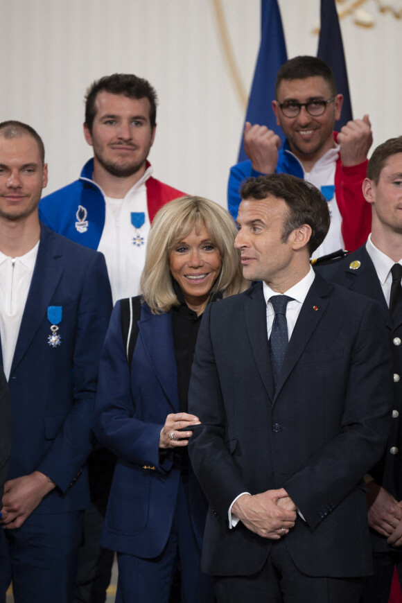 La première dame Brigitte Macron - Le président Emmanuel Macron lors d'une cérémonie en l'honneur des sportifs médaillés aux Jeux Olympiques et Paralympiques Pekin 2022 au palais de l'Elysée à Paris le 29 mars 2022. © Eliot Blondet / Pool / Bestimage