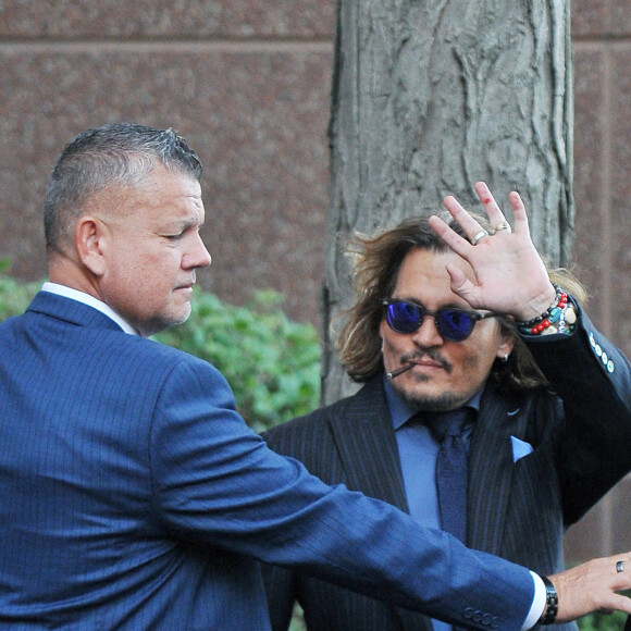 Johnny Depp et ses avocats sortent de leur hôtel à McLean, Virginie, Etats-Unis, le 13 avril 2022, pour se rendre au tribunal pour le quatrième jour du procès en diffamation avec son ex A.Heard, qui l'a accusé de violences conjugales. Johnny Depp salue ses fans avant de monter dans sa voiture. 