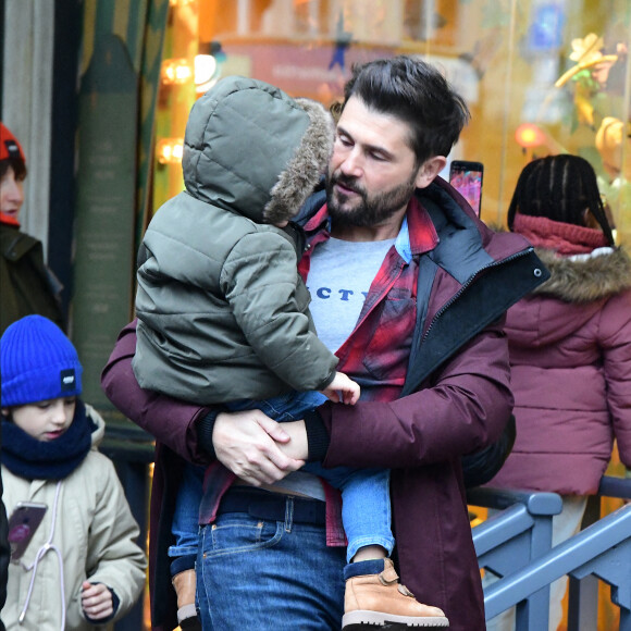 Exclusif - Christophe Beaugrand emmène son fils Valentin (3 ans) découvrir les vitrines de Noël des Grand Magasins à Paris le 19 décembre 2022.