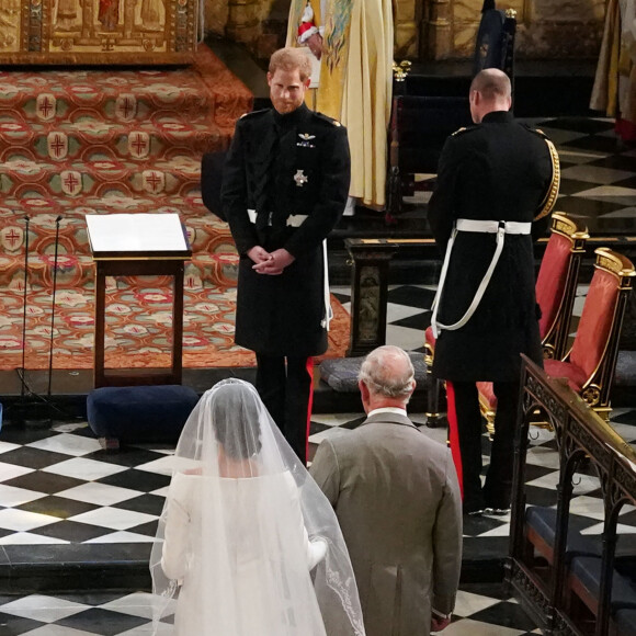 Il l'avait notamment emmenée jusqu'à l'autel pour son mariage. 
Meghan Markle, duchesse de Sussex, Le prince Charles, prince de Galles, Le prince Harry et Le prince William, duc de Cambridge - Cérémonie de mariage du prince Harry et de Meghan Markle en la chapelle Saint-George au château de Windsor, Royaume Uni, le 19 mai 2018. 