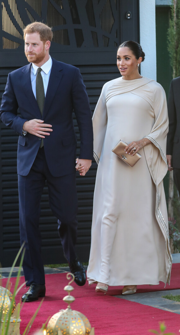 Le prince Harry, duc de Sussex, et Meghan Markle, duchesse de Sussex, enceinte assistent à une réception organisée par l'ambassadeur britannique au Maroc, Thomas Reilly, à la résidence britannique de Rabat, le 24 février 2019, dans le cadre de leur voyage officiel au Maroc. 