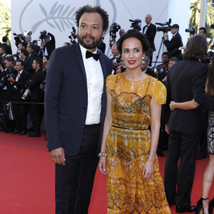 Un enfant qui a bien grandi depuis, et à qui ils ont essayé de donner la meilleure éducation possible.
Fabrice Éboué et sa compagne Amelle Chahbi (habillée en Maison Paule Ka) - Montée des marches du film "Okja" lors du 70ème Festival International du Film de Cannes. Le 19 mai 2017. © Borde-Jacovides-Moreau/Bestimage 