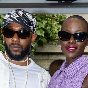 Kendrick Lamar with actress Lupita Nyong'o at Paris Fashion Week.