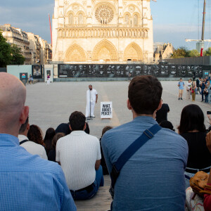 Exclusif - Slimane interprète sa nouvelle chanson "Résister" sur le parvis de Notre-Dame à Paris. Le 6 juin 2024. A quelques jours de la sortie de ce nouveau single, le chanteur a fait un happening étonnant hier soir à 20h30 entouré de 30 choristes. Ces images tournées intégreront le clip qui, lui aussi, sortira prochainement. © Christophe Clovis / Bestimage 