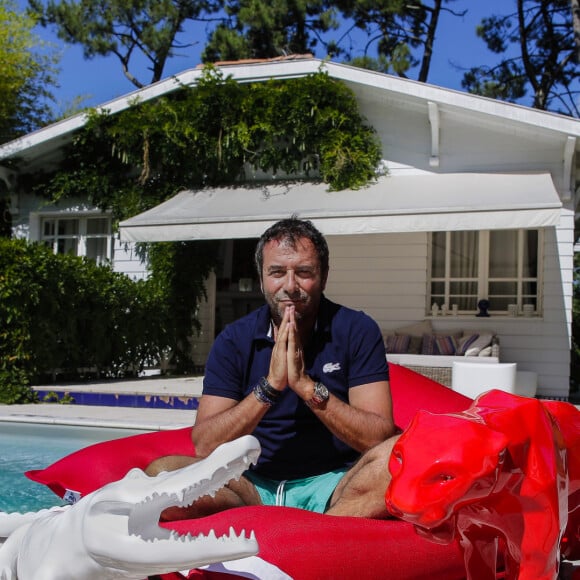 Bernard Montiel, présentateur et animateur radio pose dans sa maison du Pyla au bord de sa piscine avec des oeuvres de l artiste Richard Orlinski. Après avoir joué l'expert-media dans le jeu "La télé même l'été, Le jeu" sur C8, il passe ses vacances chez lui à Pyla-sur-Mer, son refuge depuis 30 ans. Toujours entouré des oeuvres de son grand ami Richard Orlinski, Bernard aime y recevoir ses amis autour d'un dîner et une partie de pétanque....loin du tumulte parisien ! Son adresse favorite pour manger reste l'hôtel-restaurant La Corniche, au pied de la célèbre dune du Pyla, à deux pas de chez lui, en compagnie de Sophie, la propriétaire. Il sera de retour le 28 août sur l'antenne de MFM Radio, de 9h à 12h tous les jours, et un grand retour à TPMP nouvelle version, témoignage de sa grande fidélité et amitié pour C.Hanouna. Depuis 7 ans, Bernard poursuit ses entretiens sur la chaîne TV "Animaux", où il reçoit une personnalité chaque mois qui raconte sa passion pour nos fidèles compagnons à 4 pattes. La Teste-de-Buch Pyla-Sur-Mer, le 14 juillet 2017. © Thibaud Moritz / Bestimage