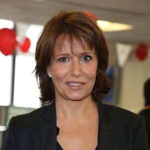 Carole Rousseau - Courtier d'un jour pour encourager les clients à passer ce jour là le maximum d'ordres dans la salle des marchés d'Aurel BGC Rue Vivienne à Paris. Le 11 septembre 2014