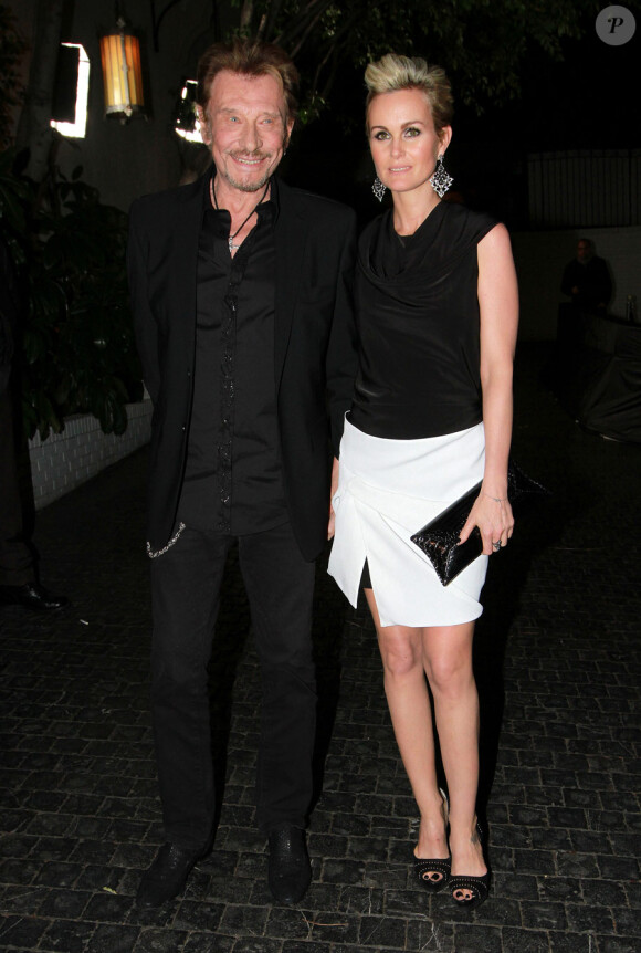 Johnny Hallyday et son épouse Laeticia lors de la soirée Christian Dior pré-Oscars, au Château Marmont à Los Angeles le 23 février 2011