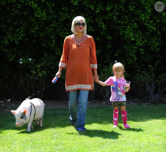 Tori Spelling, sa fille et son porc dans leur jardin à Los Angeles le 12 juillet 2011