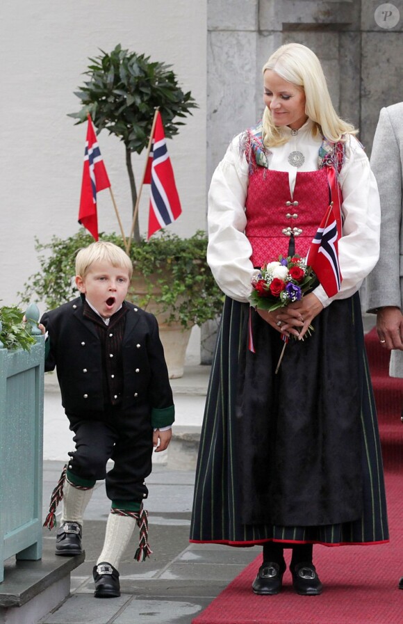 Petit coup de pompe pour le prince Sverre...
Le prince Haakon, la princesse Mette-Marit et leurs trois enfants, Marius (16 ans), la princesse Ingrid (8 ans) et le prince Christian (6 ans), ainsi que leur labradoodle Milly Kakao, devant leur résidence de Skaugum, à Asker, de bon matin le 17 mai 2012 pour la Fête nationale de Norvège.