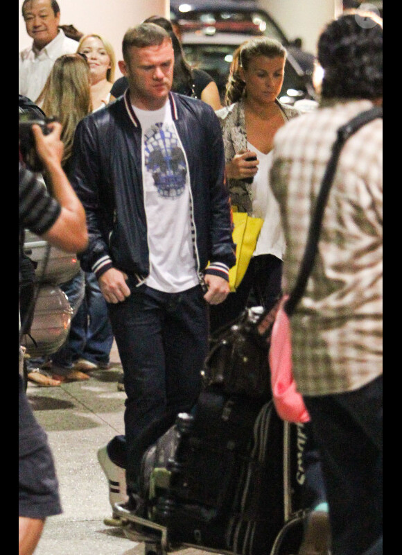 Wayne Rooney et sa femme Coleen, pas très joyeux, débarquent à Los Angeles le mardi 26 juin 2012